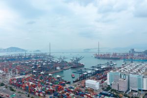 Overhead view of bustling container port in Hong Kong's New Territories, showcasing industrial marine activity.